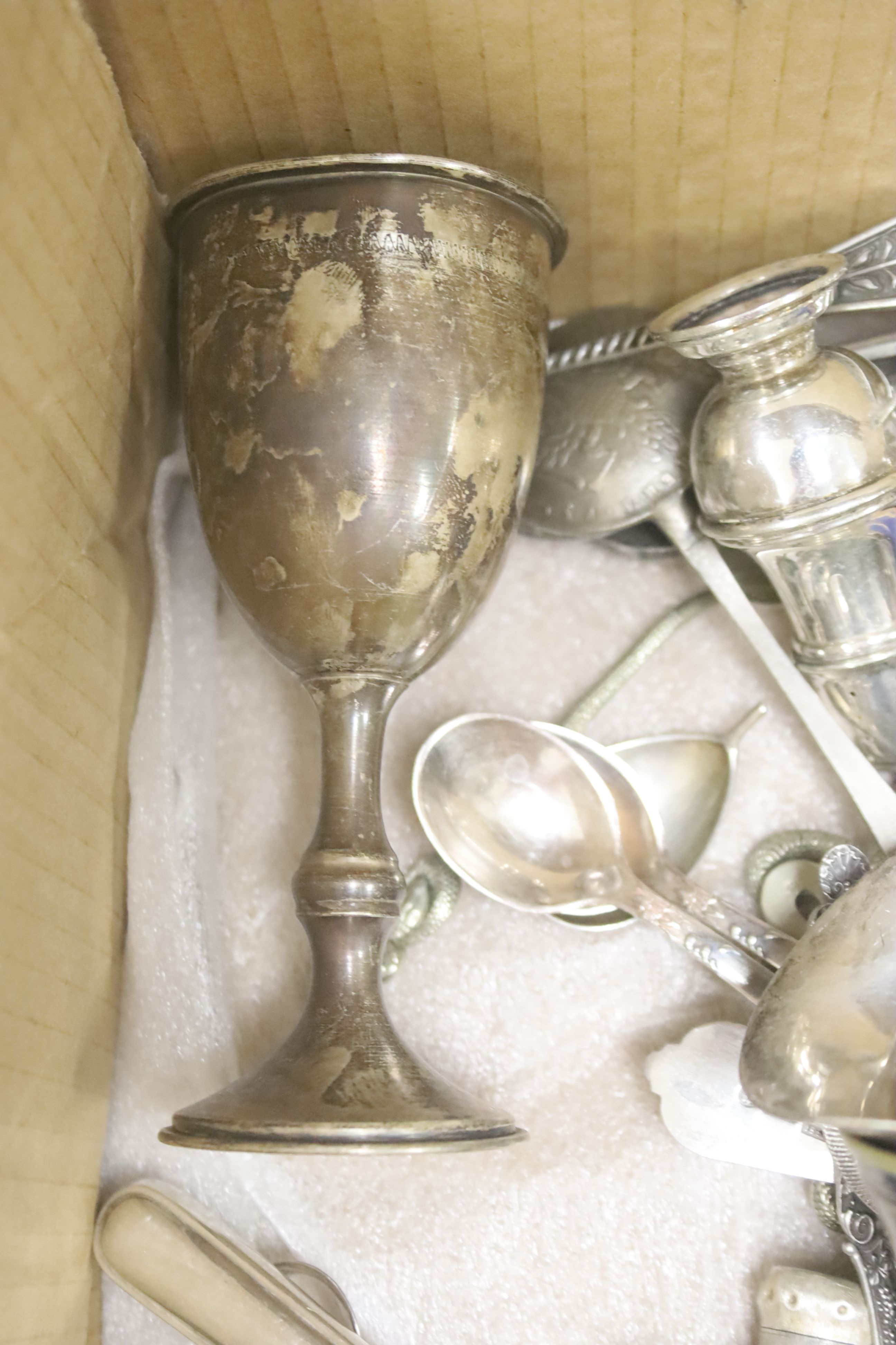 A quantity of plated tableware and cutlery